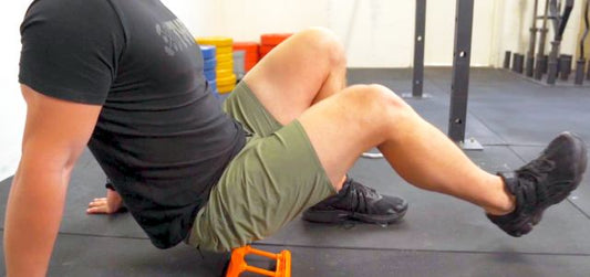 Man using Mobilization Magic™ tool on glute muscles for pain relief and mobility