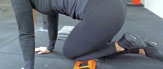 Person using Mobilization Magic Shin Splints Massage Tool on lower leg for pain relief
