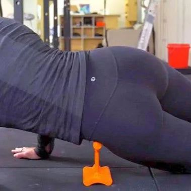Person using Mobilization Magic tool under the front of the hip while lying face down to target hip flexor tension and deep fascia release.